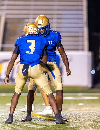 Mainland linebackers Tamaj Woodard (3) and Dennis King (1) celebrate a defensive stop against Matanzas on Sept. 25. File photo by Keishia McLendon