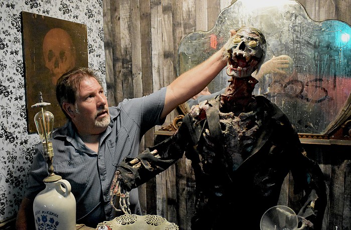 Stan Ambro adjusts the animatronic of the bartender.