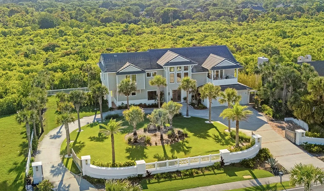 Marshfront two-story home features four bedrooms, three full and two half-bathrooms, porches, elevator, pavilion, pool, circular driveway and boardwalk.