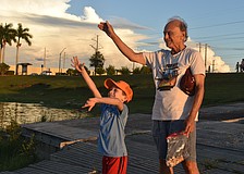 Jacob Shefrin and Michael Richker toss bread into the water to symbolize repenting past sins as part of the High Holy Days.