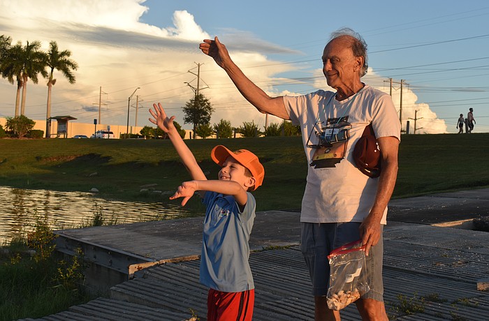 Jacob Shefrin and Michael Richker toss bread into the water to symbolize repenting past sins as part of the High Holy Days.