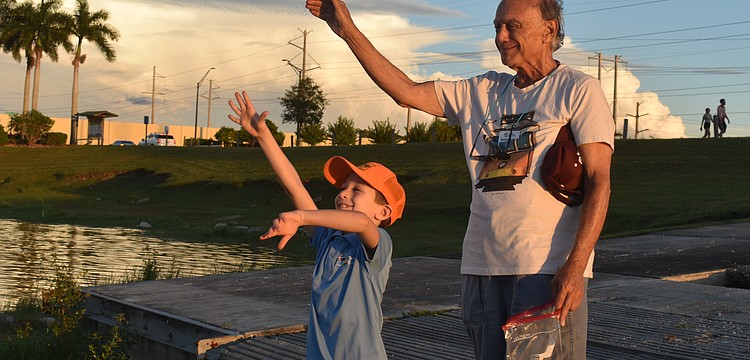 Jacob Shefrin and Michael Richker toss bread into the water to symbolize repenting past sins as part of the High Holy Days.