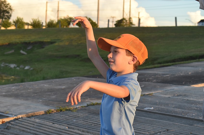Jacob Shefrin, 7, says he wasn't always a good listener and occasionally said things that were not appropriate. He tosses the bread into the water to let those things go and move on.