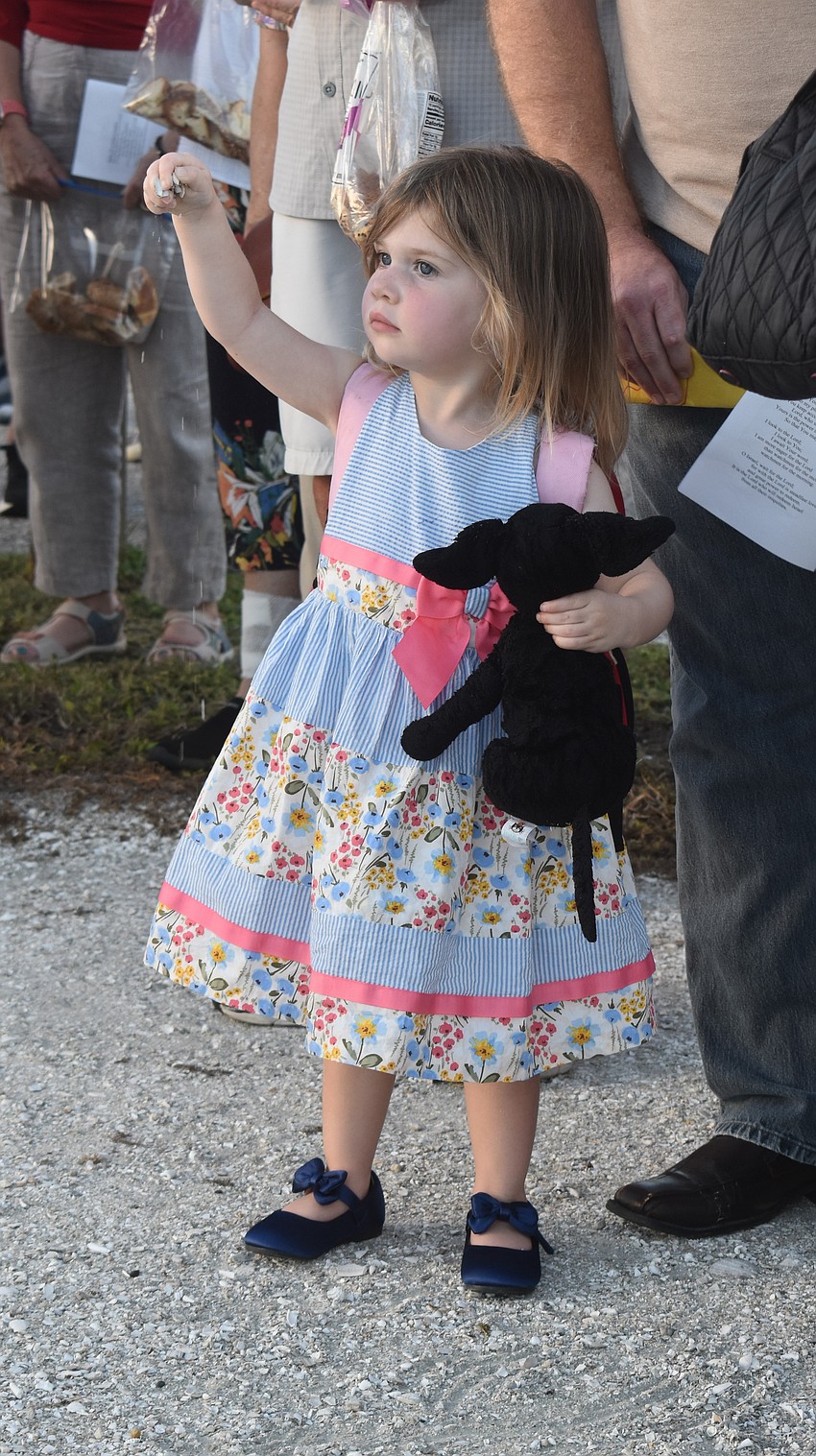 Lakewood Ranch's Hannah Hubschmitt, 2, plays with pebbles from the ground during the Tashlich ceremony at Nathan Benderson Park.