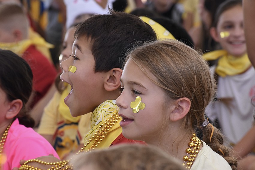 Third graders Xavier Carruyo and Aubrey Pourchier participate in the rally.