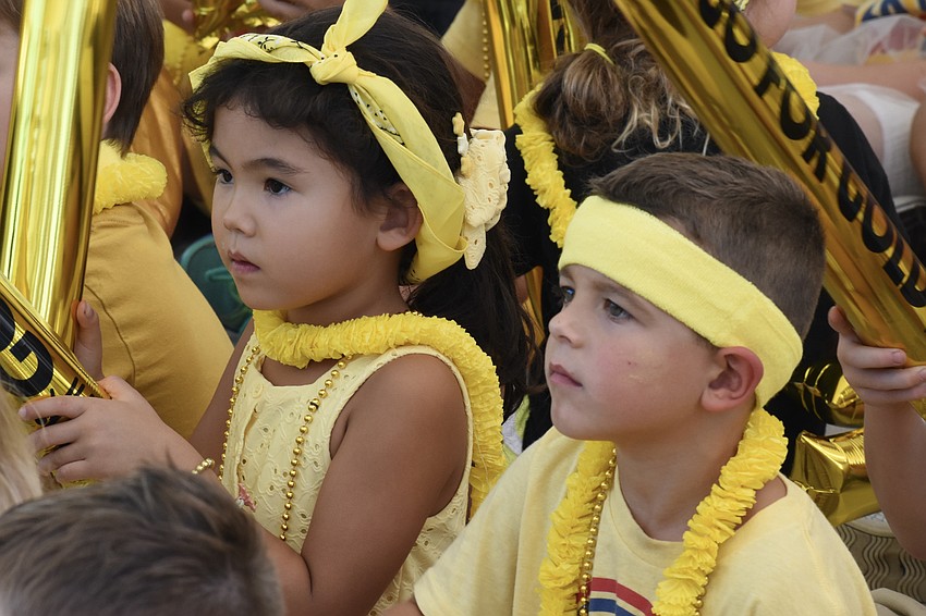 Kindergarteners Eliz Elec and Dominic Allegra watch as the rally gets underway.