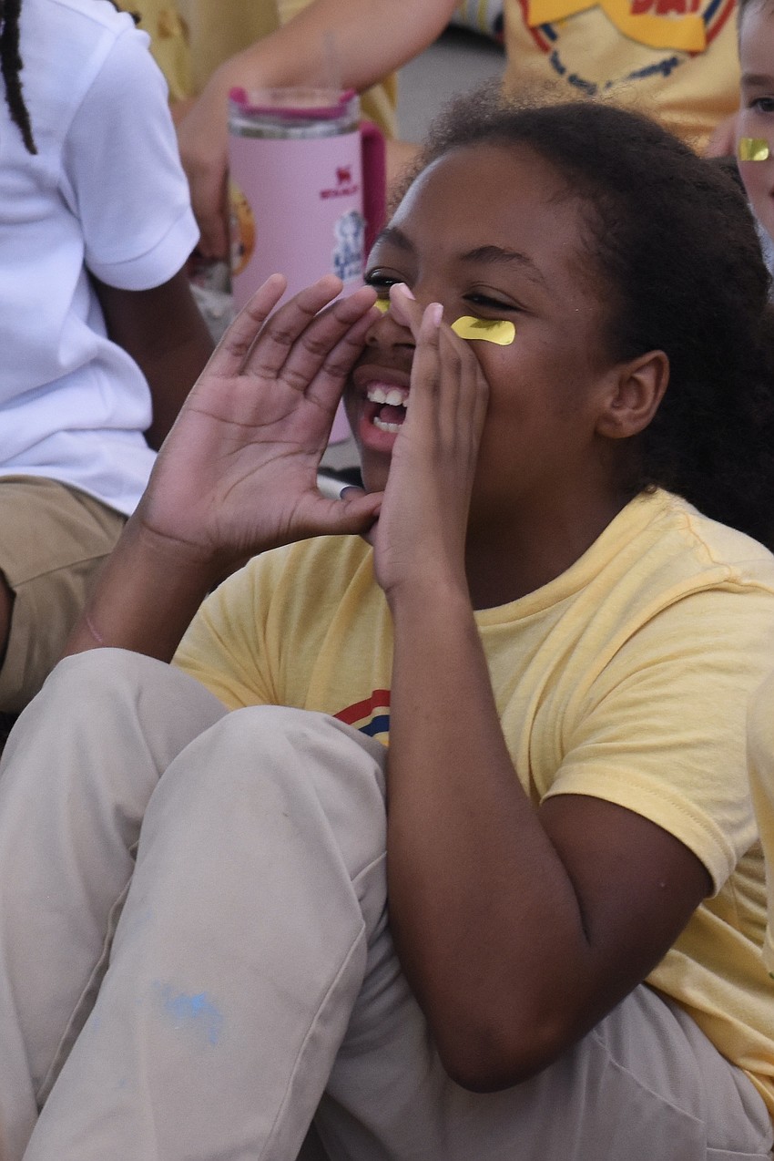Third grader Lauren Ardila Meza offers a cheer.