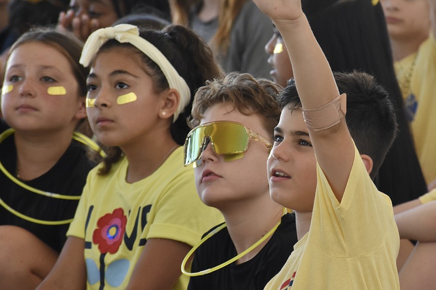 Fourth graders Valerie Wright, Sloane Sanchez, Jackson Van Norman and Giovanni Torielli show their spirit.