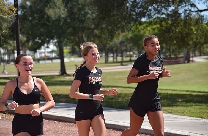 Sophomore Marley Bowen (left), junior Zoe Zondor (center) and junior Jasmine France (right) of Sarasota girls' cross country run together during a Sept. 29 practice at Payne Park.