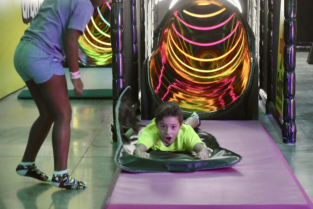 Myakka City's Bennett Simunovic, 8, wasn't expecting to fly out of the slide so fast, but he doesn't mind.