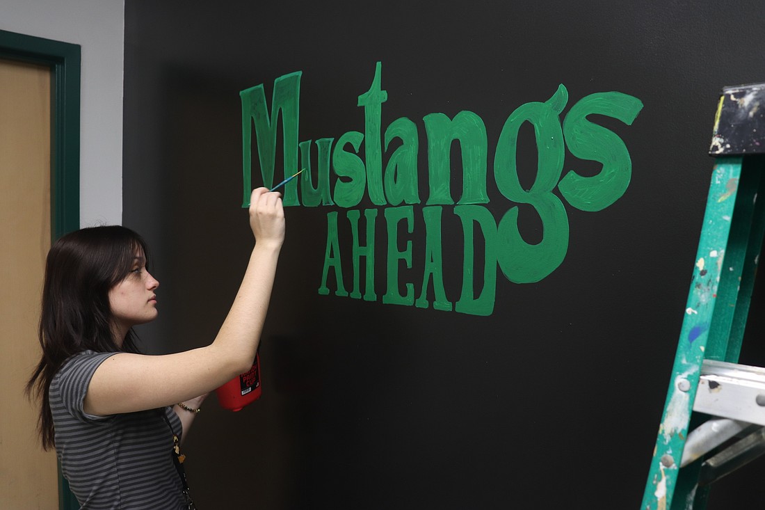 Senior Isabelle Harrell begins work on another mural at Lakewood Ranch High School.