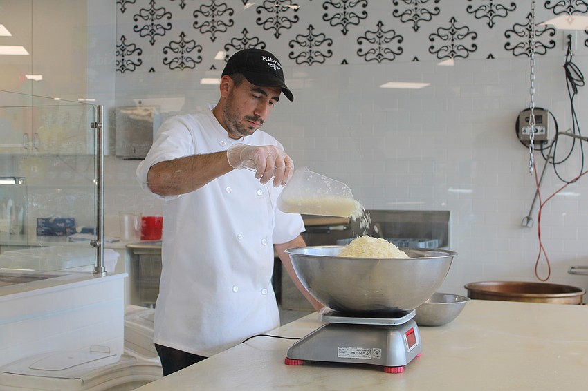 Dino Coit, assistant manager at the Kilwins treat shop on St. Armands, whips up a batch of cookies and cream fudge in a live demo for customers during the grand reopening on Sept. 27.
