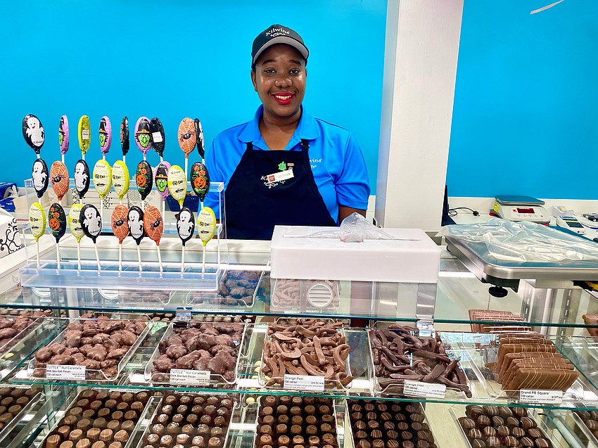 Kilwins team member Georgia Nembhard doles out chocolate truffles at the reopening of the St. Armands shop.