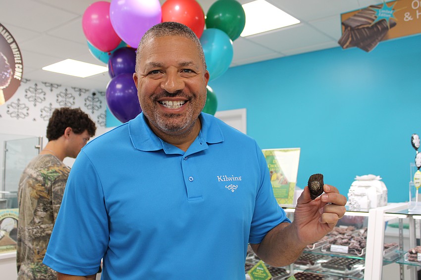 Kilwins President and CEO Brian Britton shows off the new pistachio-flavored, Dubai-inspired chocolate bonbon the St. Armands store featured at its grand reopening on Sept. 27.