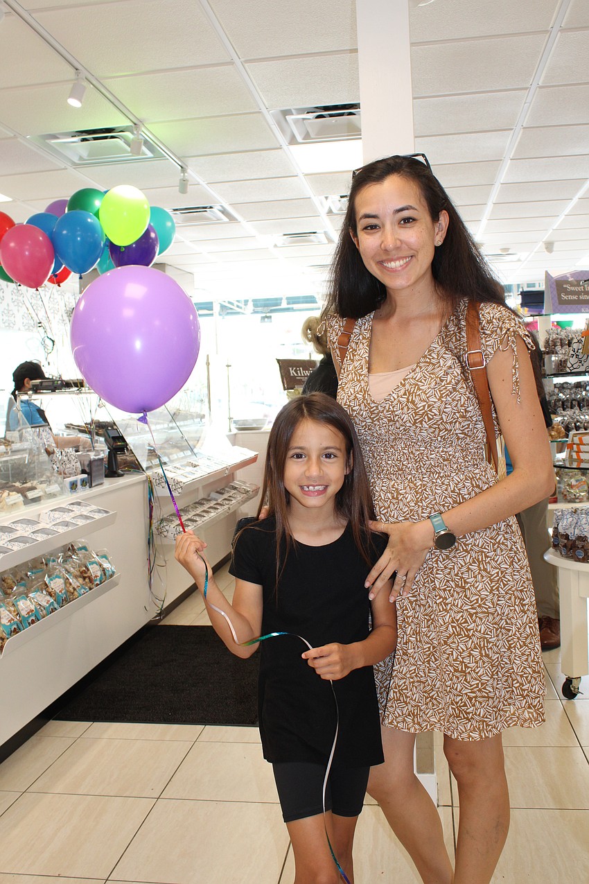 New customers Vivian and Anna Flewelling stop in for the grand reopening of Kilwins treat shop on St. Armands Circle.