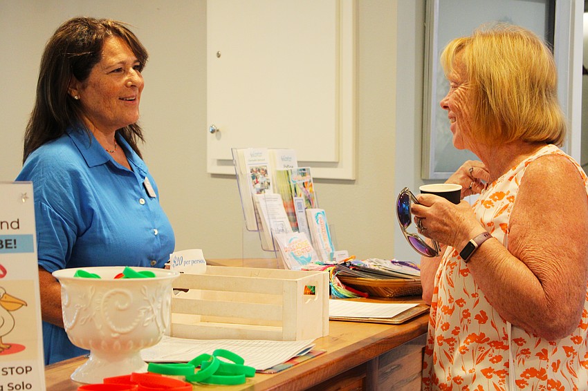 The Paradise Center Executive Director Amy Steinhauser speaks with Longboat Key resident Billie Dawson, who expressed interest in volunteering with the community center.