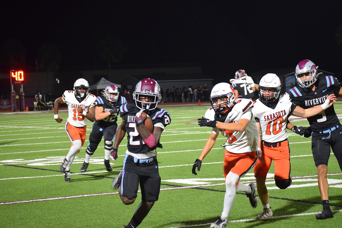 Toryeon James (21) of Riverview football sprints down the sideline en route to a touchdown against Sarasota. The junior ran for nearly 300 yards in the team's Week 6 defeat of its longtime rival.