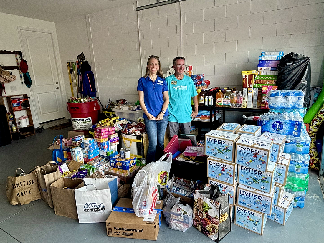 Erika_Spence with James Roper and the food collected for Second Harvest. Courtesy of Second Harvest Food Bank of Central Florida