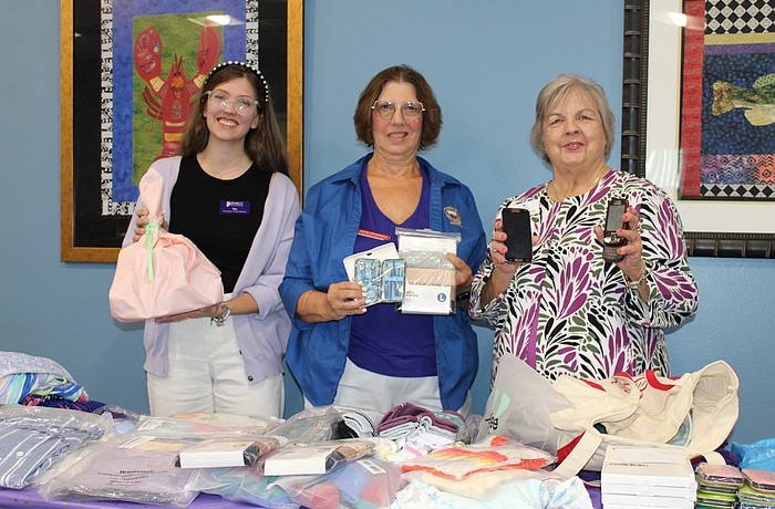To recognize Domestic Violence Awareness month, GFWC's Woman's Club of Sarasota, including members Diana Freidinger, center, and Sharlene Cox, right, presented victim advocate Talia Casey with $1,400 and donated items to support Safe Place and Rape Crisis Center's mission.