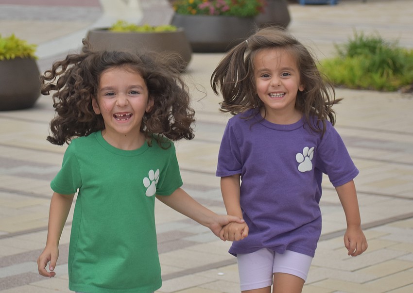 Lakewood Ranch sisters Angelina Vanslyck, 7 and Carmela Vanslyck, 5, 
dance along as No Filter performs a cover of 