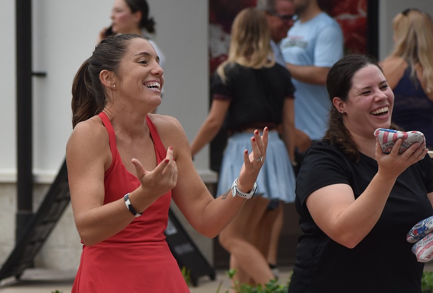 Liz Gutierrez and Catie Turgeon play cornhole, hosted by MVP Sports & Social. It is the largest recreational cornhole league in the nation.