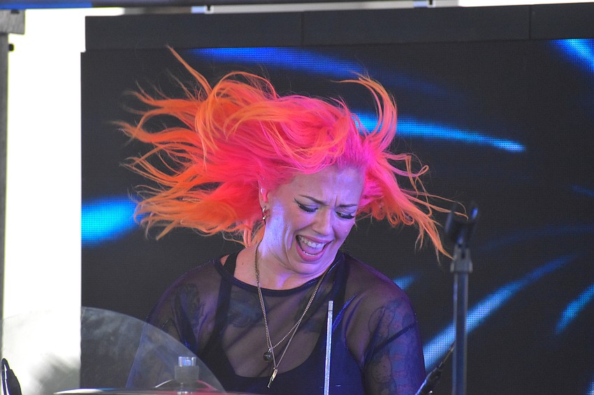 No Filter drummer Natalie Mustang uses her pink and orange flame-like hair to express herself while performing.