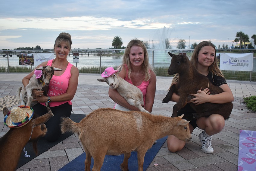 Janelle Ryan, Corinn Smith and Aliyah Burnett welcome their goat friends into their arms at Ranch Nite Wednesday.