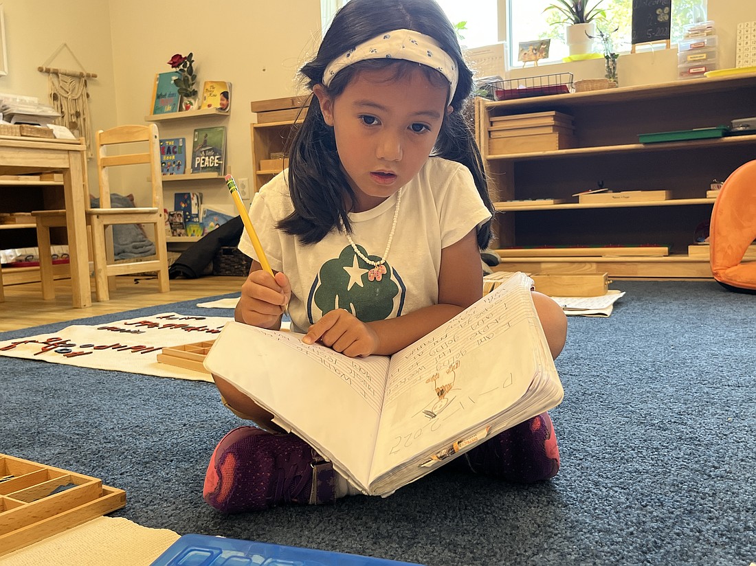 Kindergartner Margot Lopez created a sentence and worked on her writing skills.