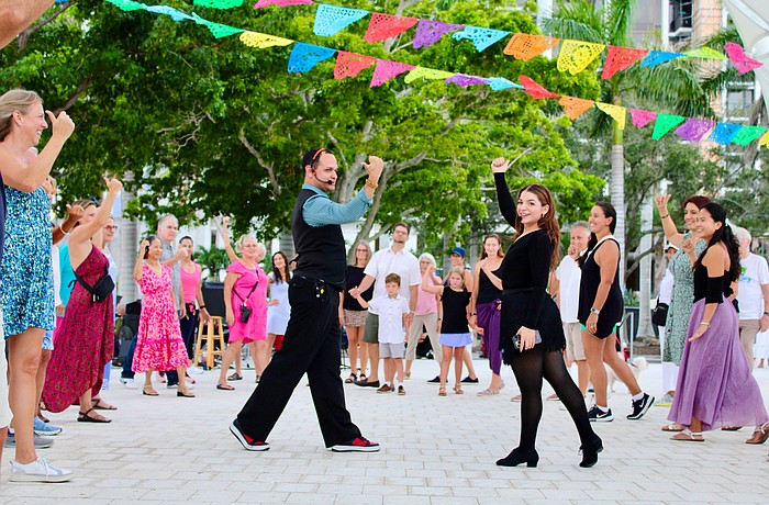 Instructors Juan Uribe and Miranda Vidro from Fred Astaire Dance Studios demonstrate some salsa dance moves at The Bay's third anniversary celebration.