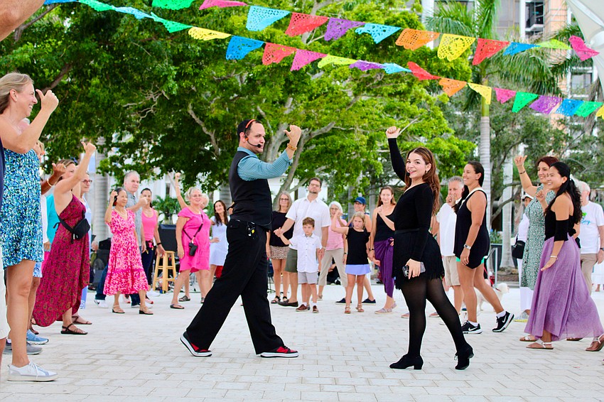 Instructors Juan Uribe and Miranda Vidro from Fred Astaire Dance Studios demonstrate some salsa dance moves at The Bay's third anniversary celebration.