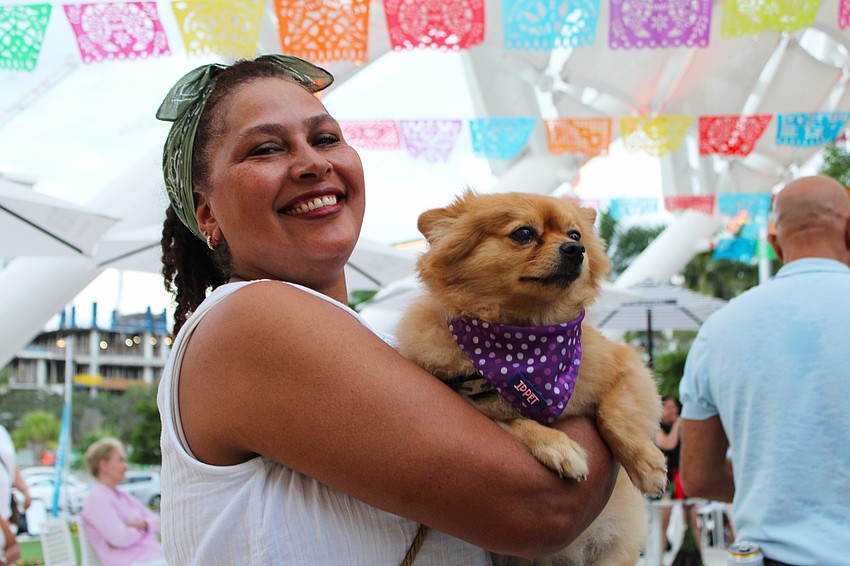 Olga Camacho and her dog, Macarena, join in the anniversary festivities at The Bay.