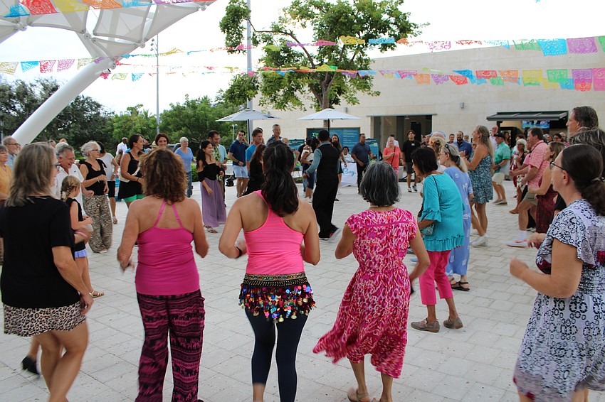 Community members smiled while testing out new skills, learning how to salsa with the assistance of the Fred Astaire Dance Studios and Millie Puente's band.