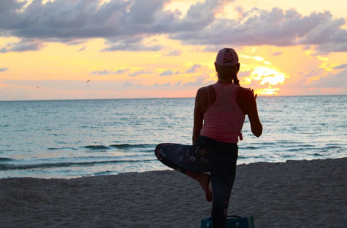 Yoga instructor Angela Mali has been leading by-donation sunset yoga classes on Longboat Key for three years. Whether she will be able to continue the classes is in question as she and town leaders debate usage of the beach.