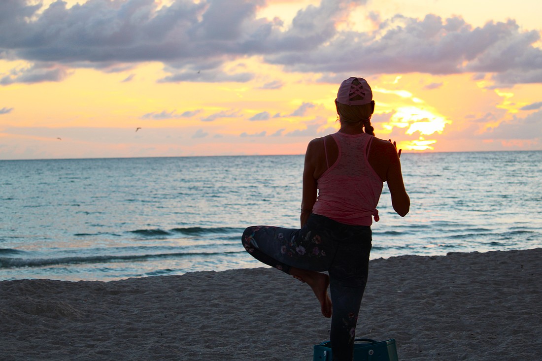 Yoga instructor Angela Mali has been leading by-donation sunset yoga classes on Longboat Key for three years. Whether she will be able to continue the classes is in question as she and town leaders debate usage of the beach.