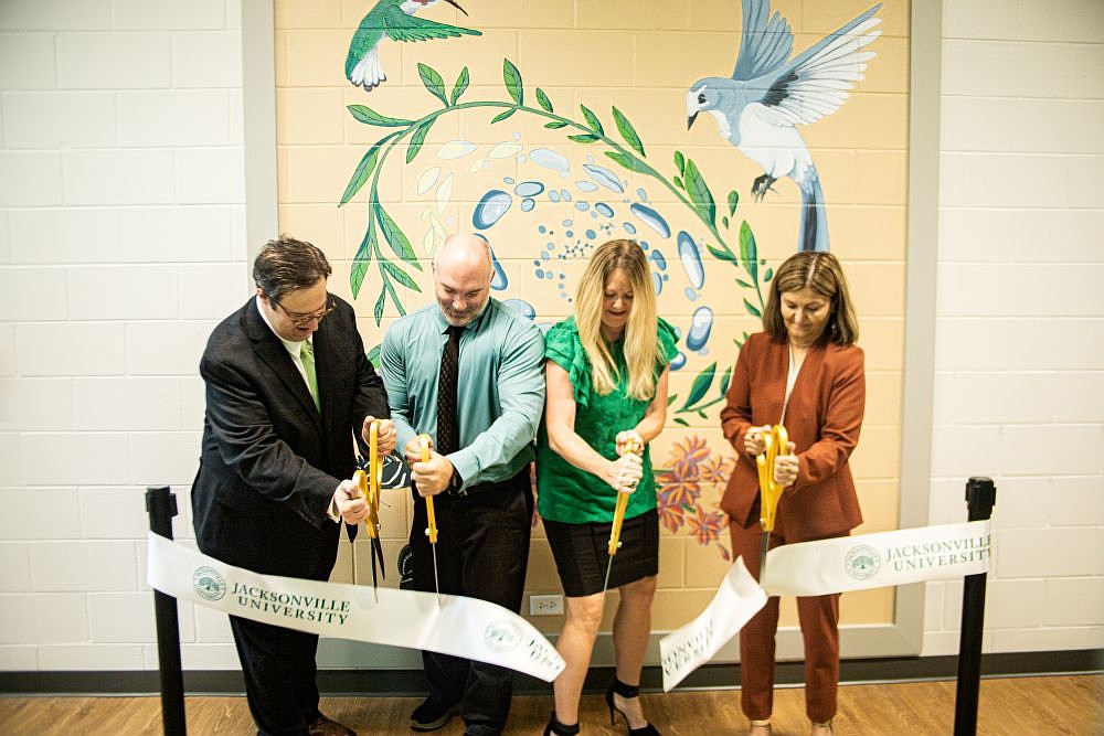 From left, Chris Corbo, Dean of the Linda Berry Stein College of Arts & Sciences at Jacksonville University; William Penwell, chair of the Biology Department; Kara Conway, director of the School of Sciences and Mathematics; and Sherri Jackson, interim provost and senior vice president of academic affairs cut the ribbon on the renovated Reid Medical Science Center at the Arlington campus.