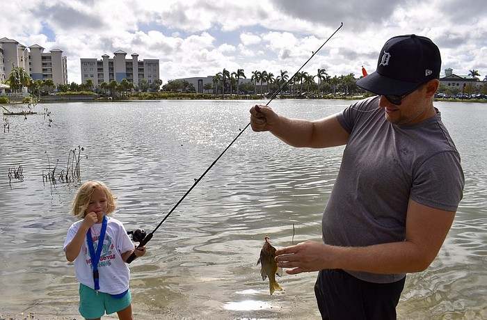Sarasota's Tori Bruinsma, 6, blows her whistle after catching another fish. Dad Kevin Bruinsma says that fishing is the first activity his daughter has gravitated towards on her own.