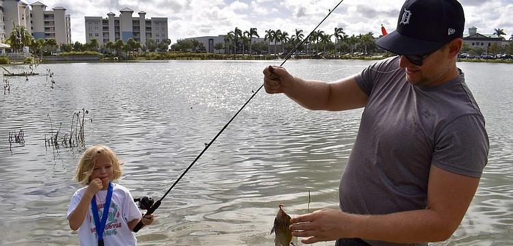 Sarasota's Tori Bruinsma, 6, blows her whistle after catching another fish. Dad Kevin Bruinsma says that fishing is the first activity his daughter has gravitated towards on her own.