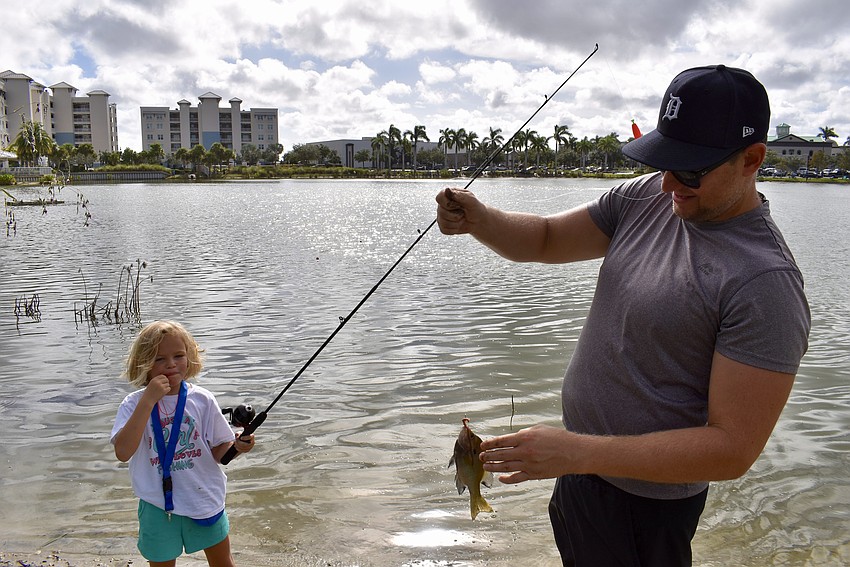 Sarasota's Tori Bruinsma, 6, blows her whistle after catching another fish. Dad Kevin Bruinsma says that fishing is the first activity his daughter has gravitated towards on her own.