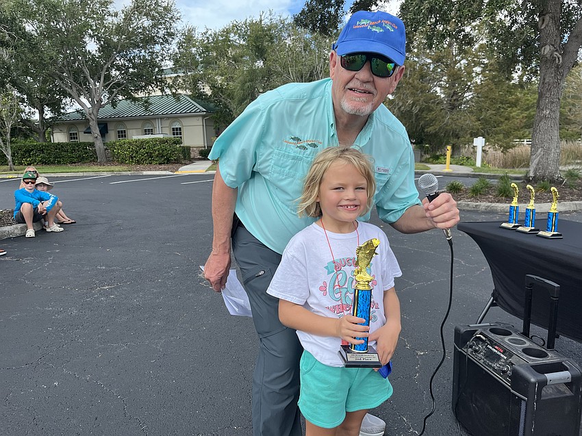 Ed Van Stedum, president of the Lakewood Ranch Anglers Club, presents Tori Bruinsma with her trophy.