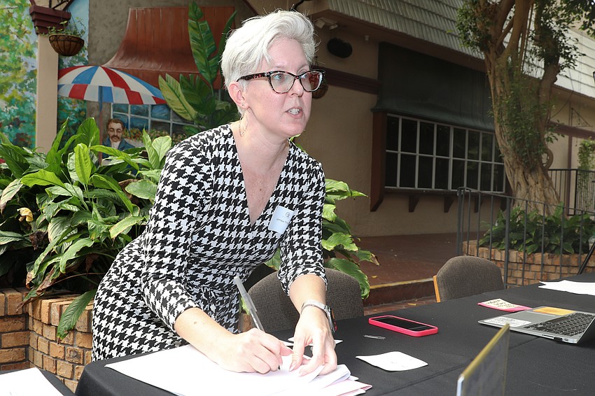 Jamee Thumm registers guests at the Pathways to Resilience luncheon at Michael's On East.