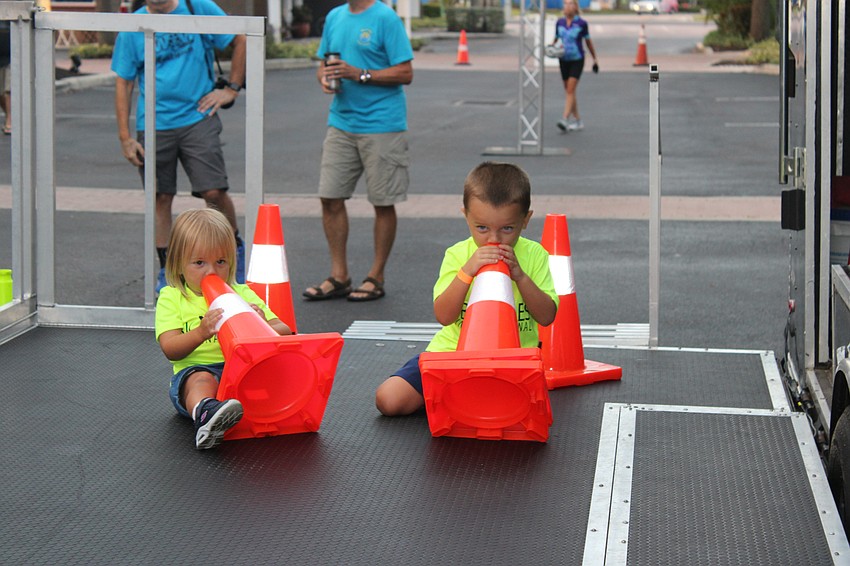 Harper Culpepper 2, and her brother Greyson Culpepper, 3, aren't riding, but that doesn't mean they can't enjoy the Women on Wheels Ride atmosphere.
