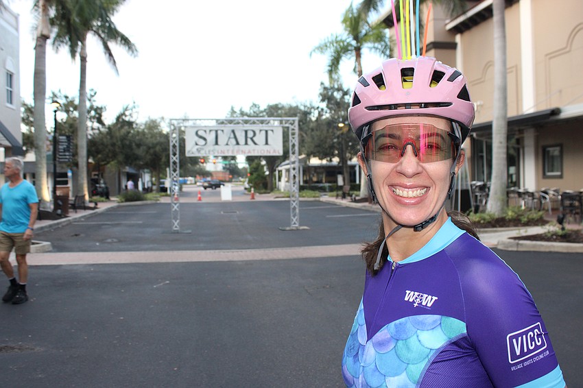Dorys Ribeiro of Clearwater adds a little color to the top of her helmet to identify herself as a member of the St. Petersburg Bicycle Club.