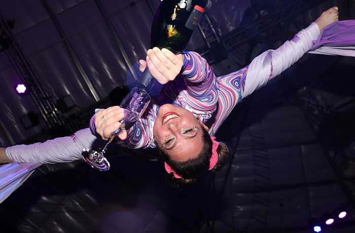 Aerialist and CAC coach Siena Hartzell pours champagne from a unique perspective.