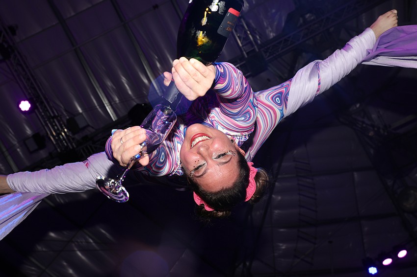 Aerialist and CAC coach Siena Hartzell pours champagne from a unique perspective.