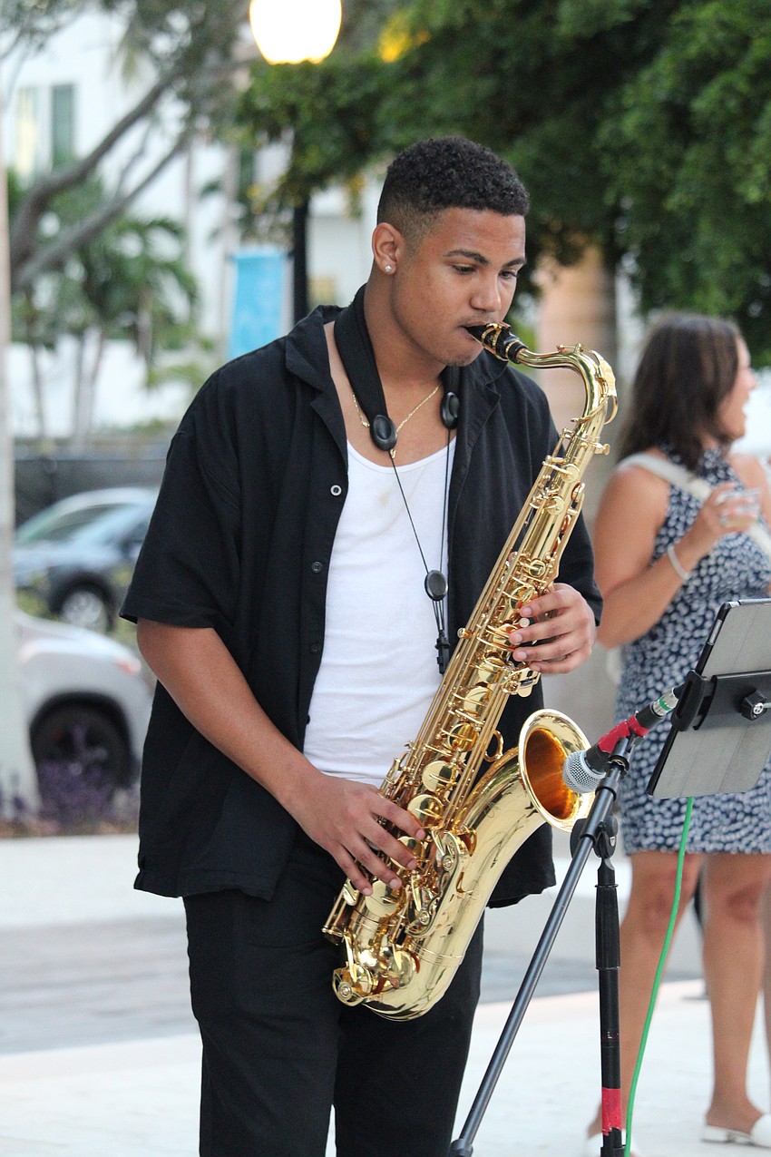 As night falls at The Bay's third anniversary celebration, Millie Puente and band members including saxophonist Eduardo Marichales pick up the tempo.