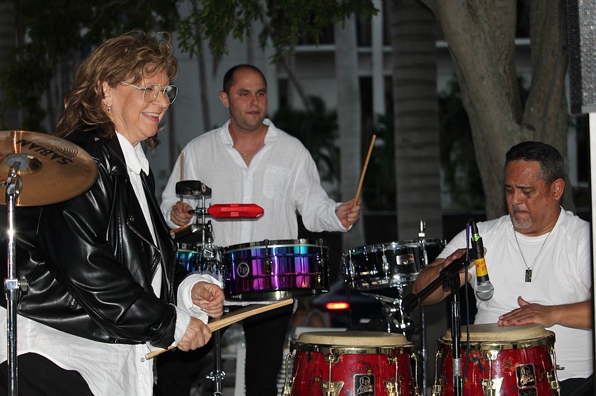 Grammy-winner Millie Puente shares a smile with drummers Miguel Hernandez and Frankie Bermudez.