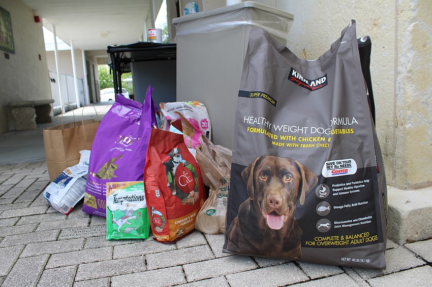 Attendees at St. Boniface Episcopal Church's annual pet blessing also brought pet food donations for the Humane Society of Sarasota County.