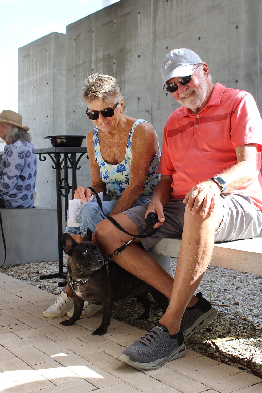 Ziggy the 5-year-old French Bulldog looks up adoringly at owners Nick and Susan Stavros.