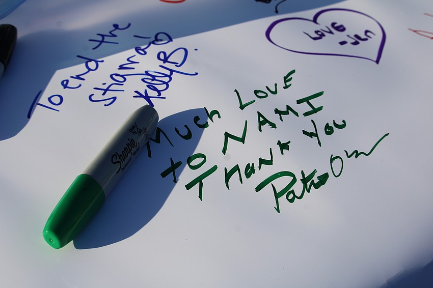 Participants in this year's local NAMIWalks wrote down their reasons for joining on a banner.