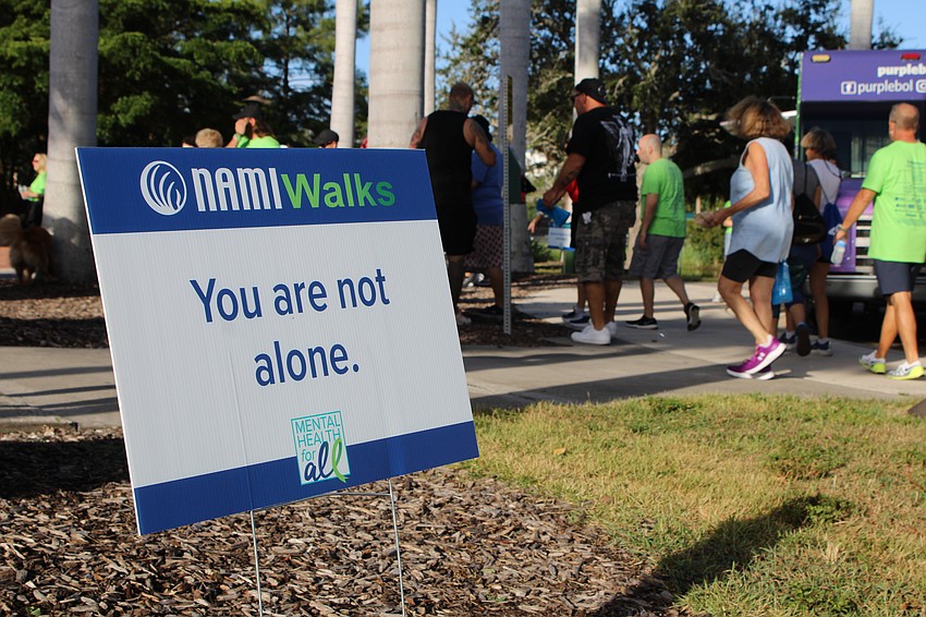 Participants in the 5th annual NAMIWalks Sarasota and Manatee make their way to the start line. The walk did not have a set distance, but participants were invited to walk as many laps as they liked.